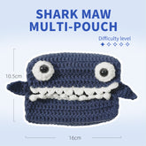 Crocheted shark-shaped multi-pouch with measurements on a light blue background